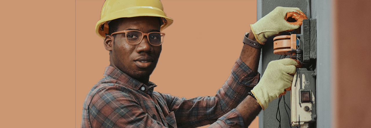 Electric company worker looking confused while interconnecting electric wires.