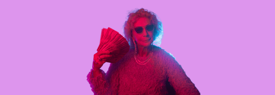 Grandmother in sunglasses fanning herself with cash.