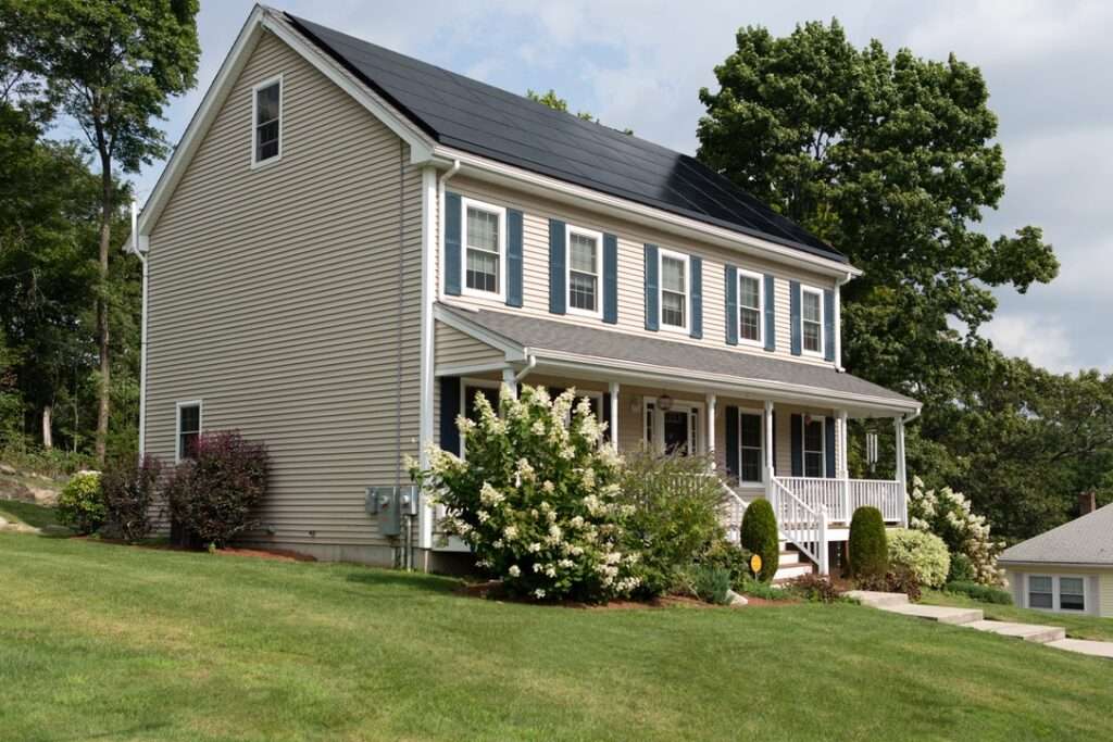 Home with all-black solar panels covering the entire front pitch of the roof.