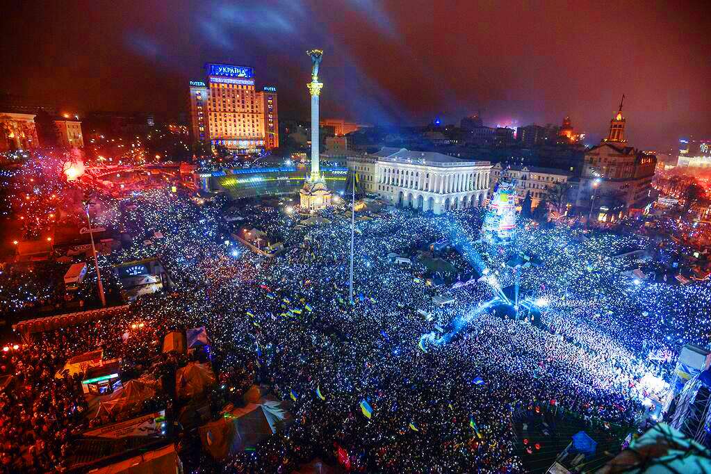 Crowd of thousands Ukrainians protesting at night in the Maidan Nezalezhnosti Square in Kyiv, Ukraine during the 2014 "Revolution of Dignity"