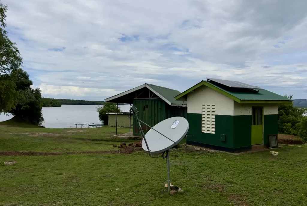 Two single-room facilities used by the rangers at Lake Mburo National Park. The facilities are on the edge of the lake, one of the structures has three large solar panels on the roof.