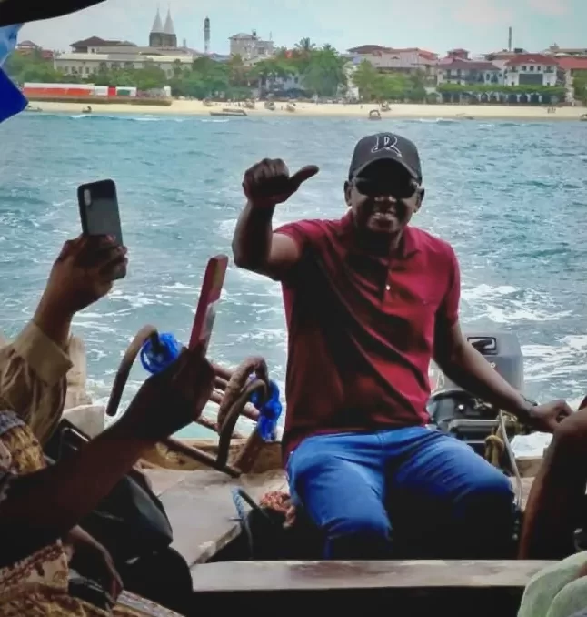 Mody Black captains a motorboat full of people as they depart from Stone Town, Zanzibar, Tanzania.