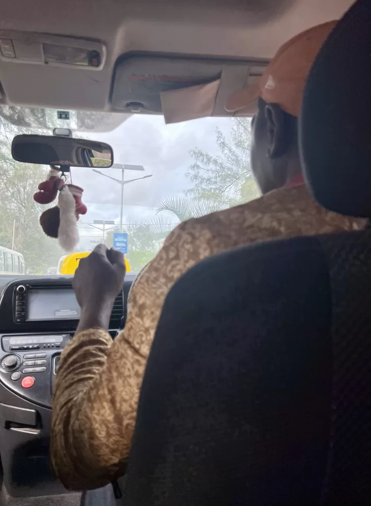 Mody driving down a road in Zanzibar Tanzania that lined with solar-powered street lights.